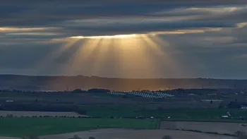 Gods rays on a cloudy spring evening over a solar farm 4.jpg